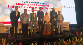 Indonesian delegation stands on a black stage